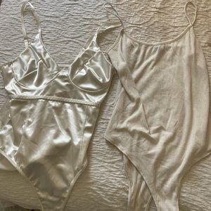 Two white bodysuits